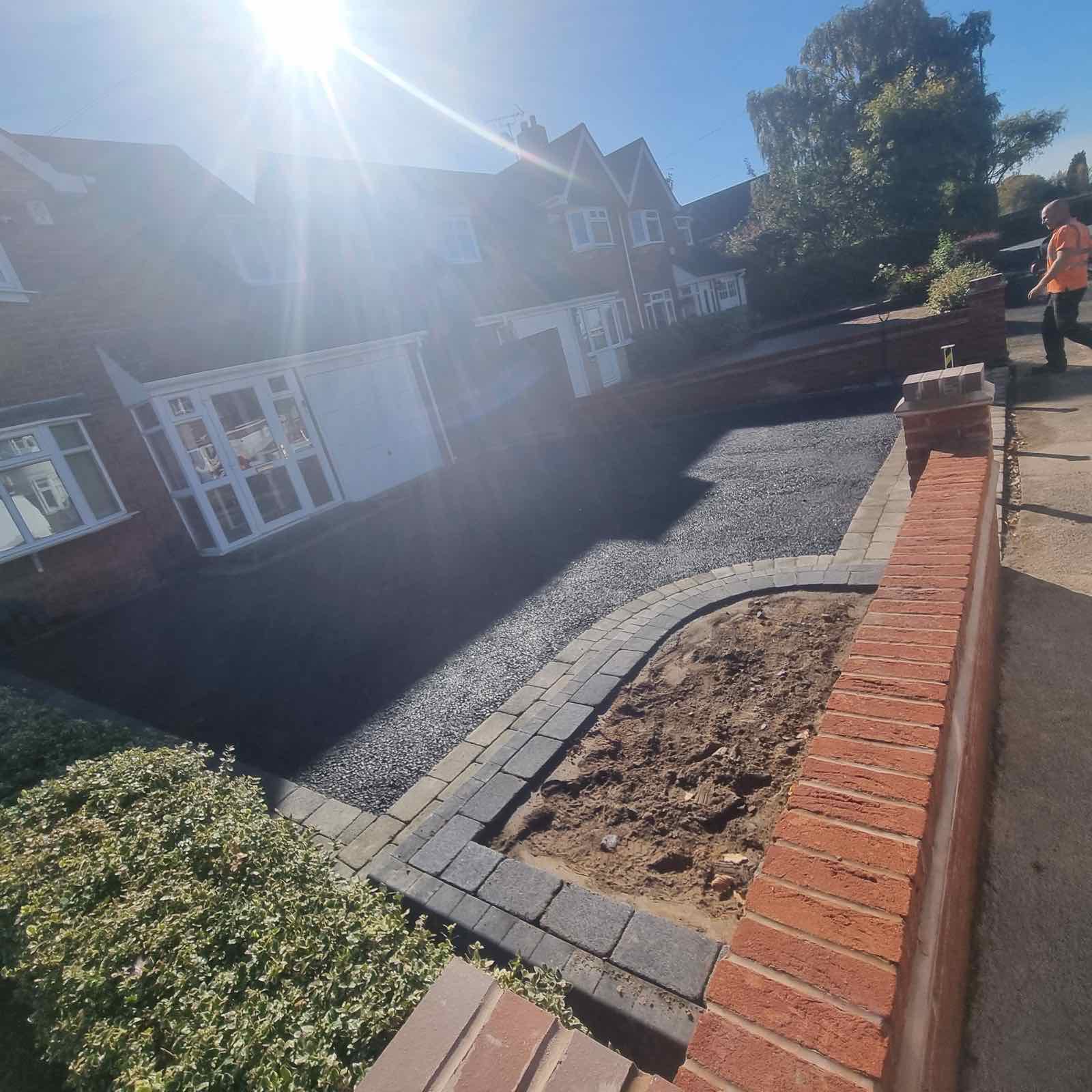 Tarmac driveway with tumbled blocks, planter and posts